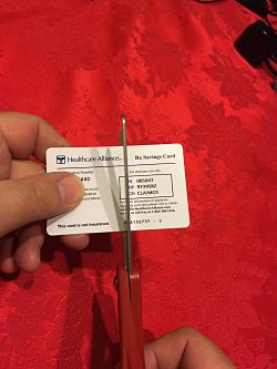 image of card being cut in half