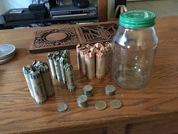 Photo of rolled coins and the jar